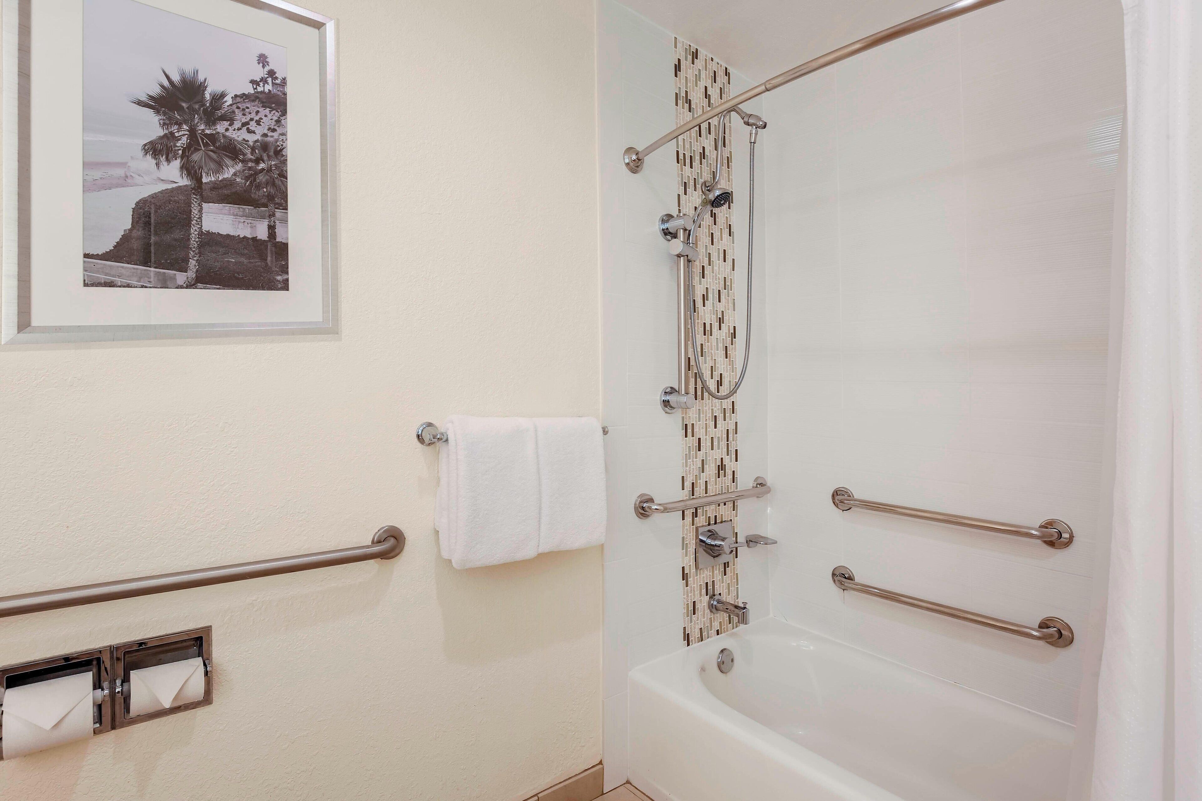 combined shower/bathtub, designer toiletries, hair dryer, towels