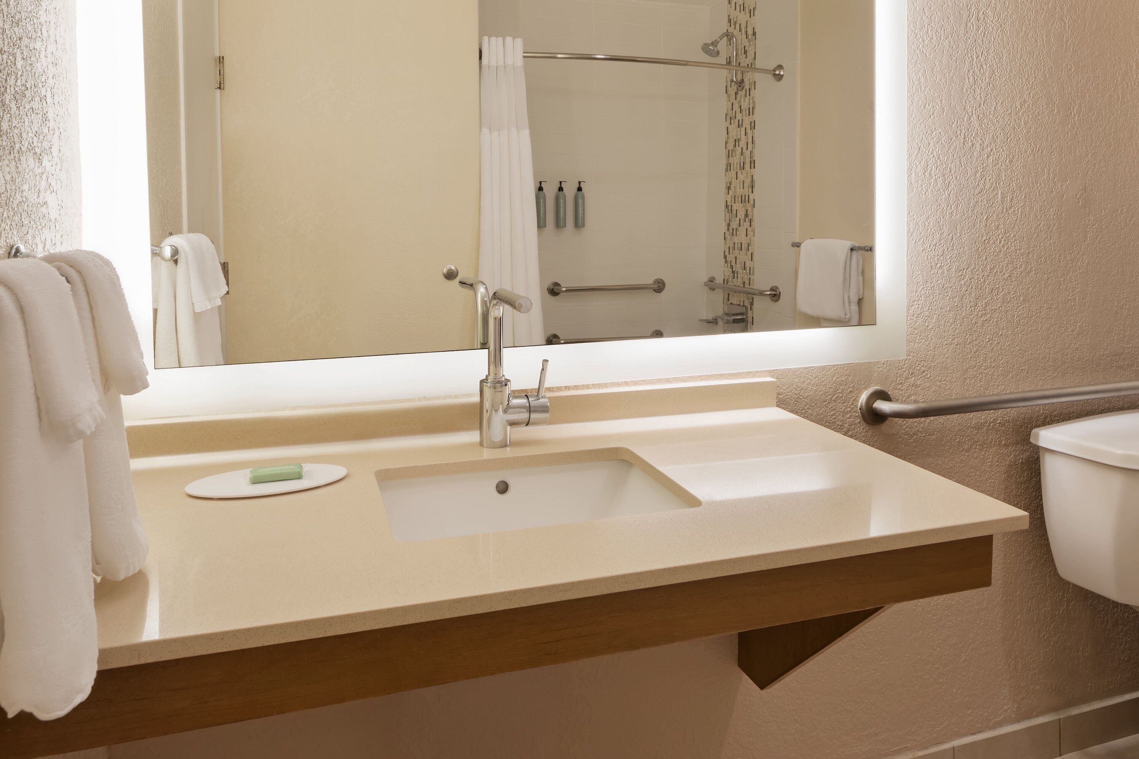 combined shower/bathtub, designer toiletries, hair dryer, towels