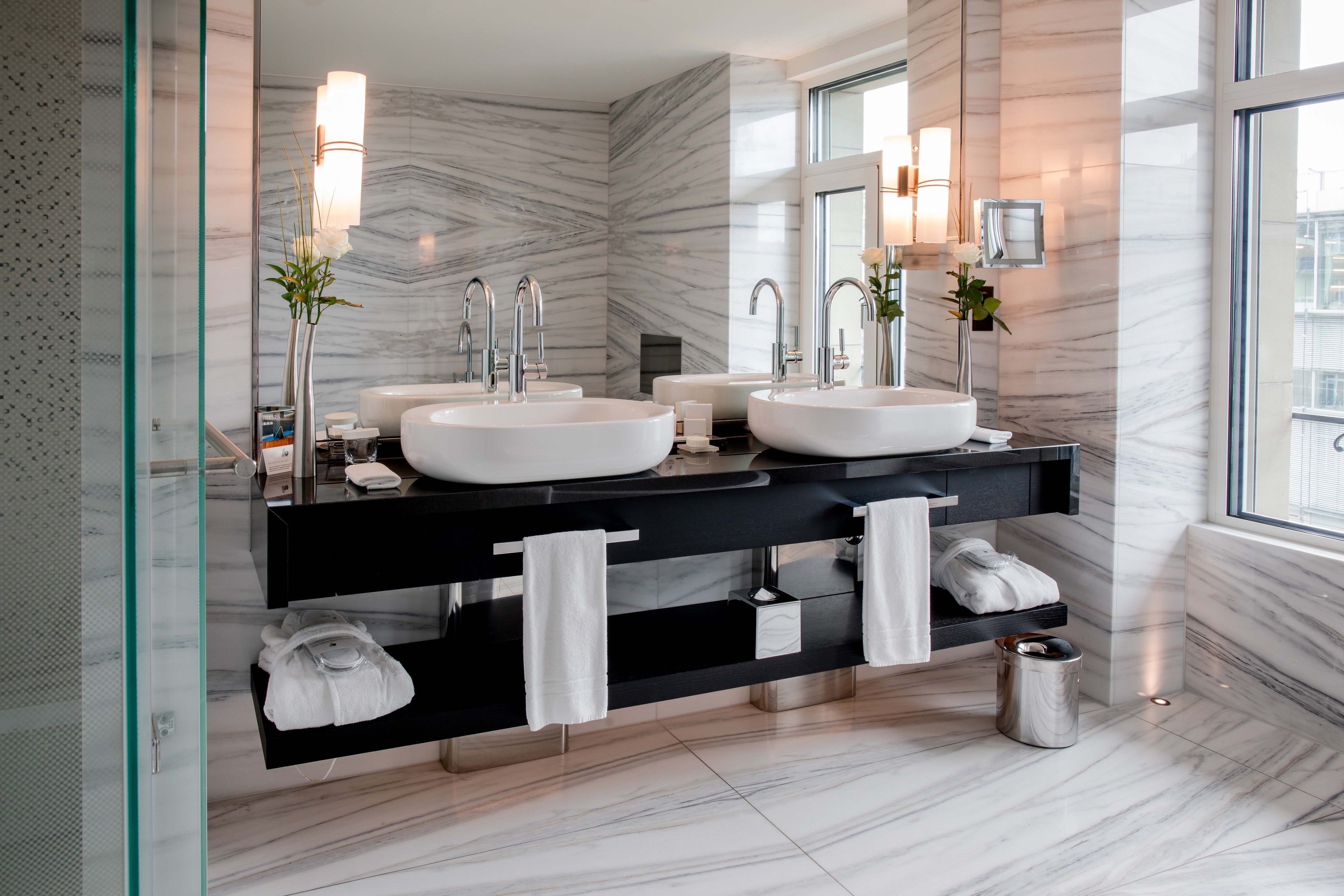 luxury living studio | bathroom | rainfall showerhead, designer toiletries, hair dryer, bathrobes