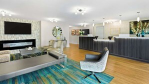 A modern hotel lobby with a reception desk, seating area, and a flat-screen TV. - Best Western Naperville Inn (Naperville)