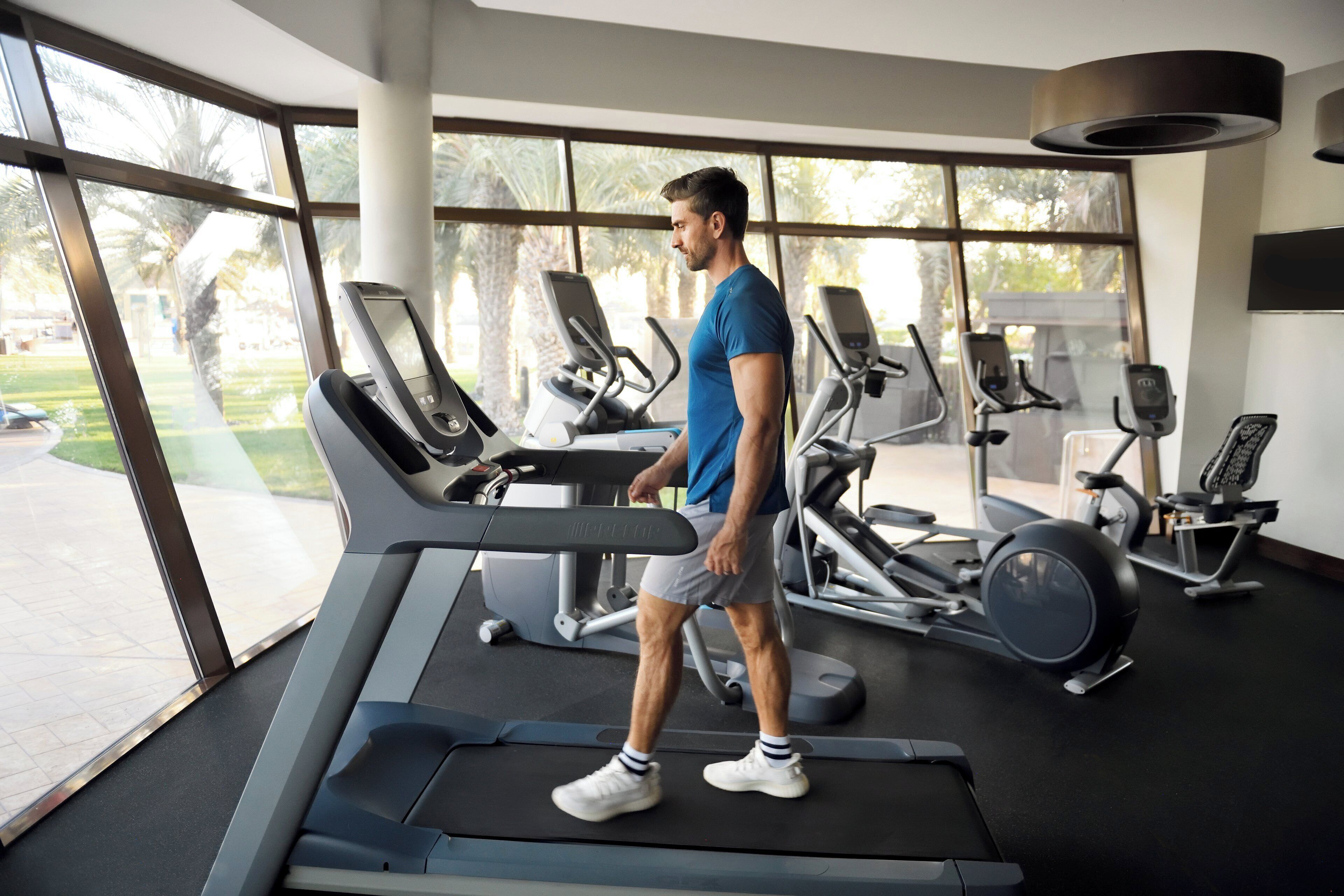 A gym with treadmills, exercise bikes, and weight machines.