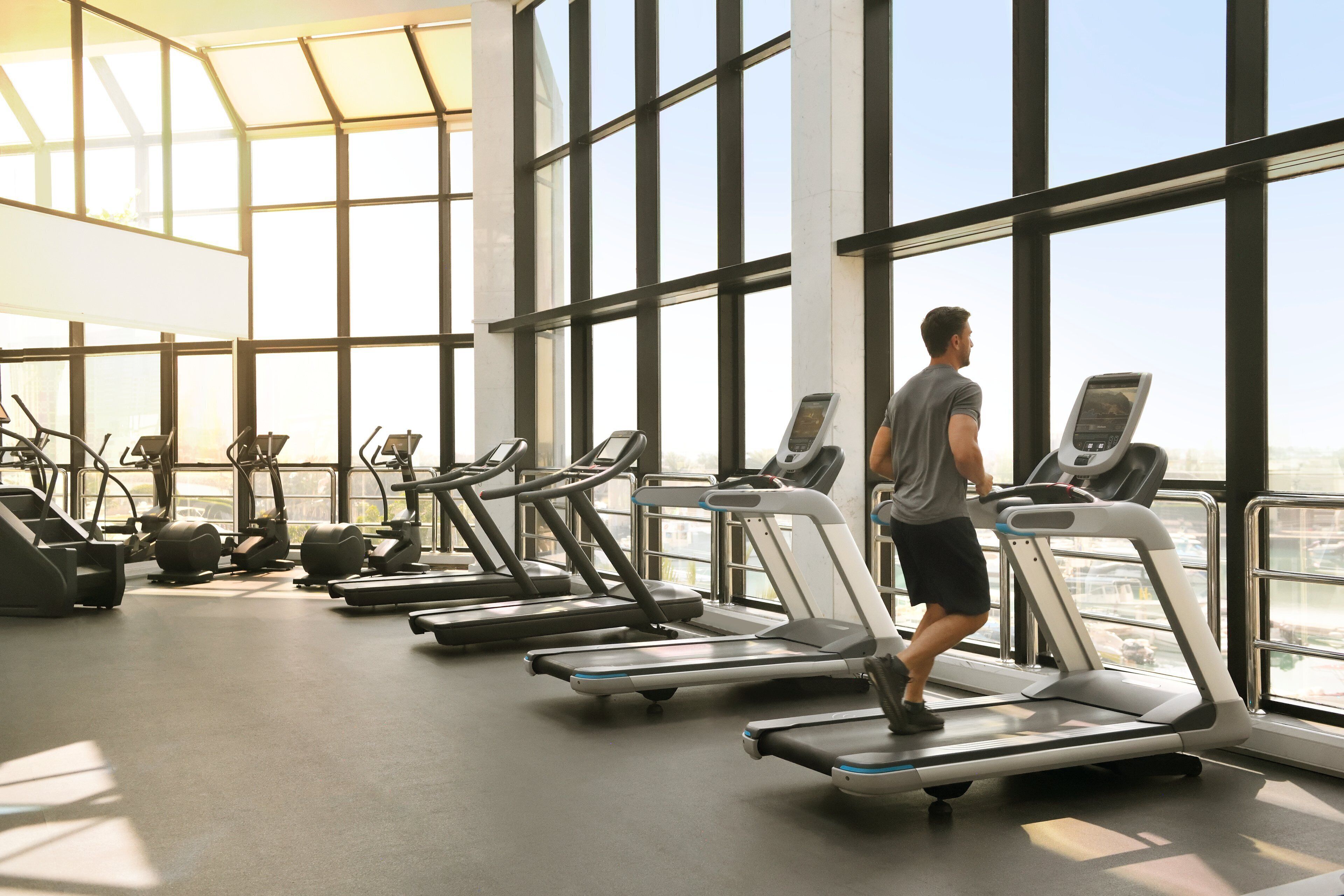 A gym with treadmills, ellipticals, and other cardio equipment.