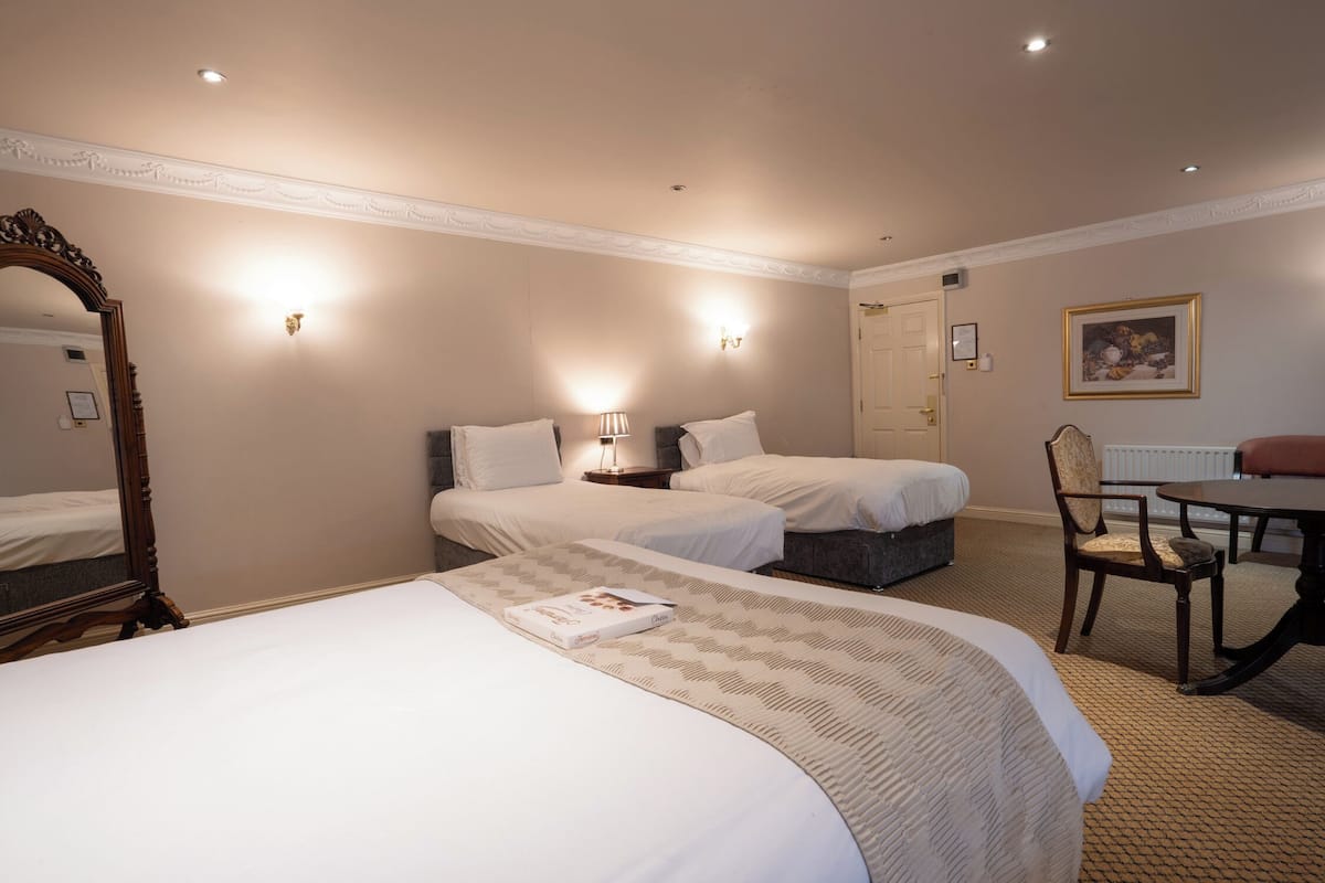 family double room, multiple beds | individually decorated, individually furnished, desk, iron/ironing board