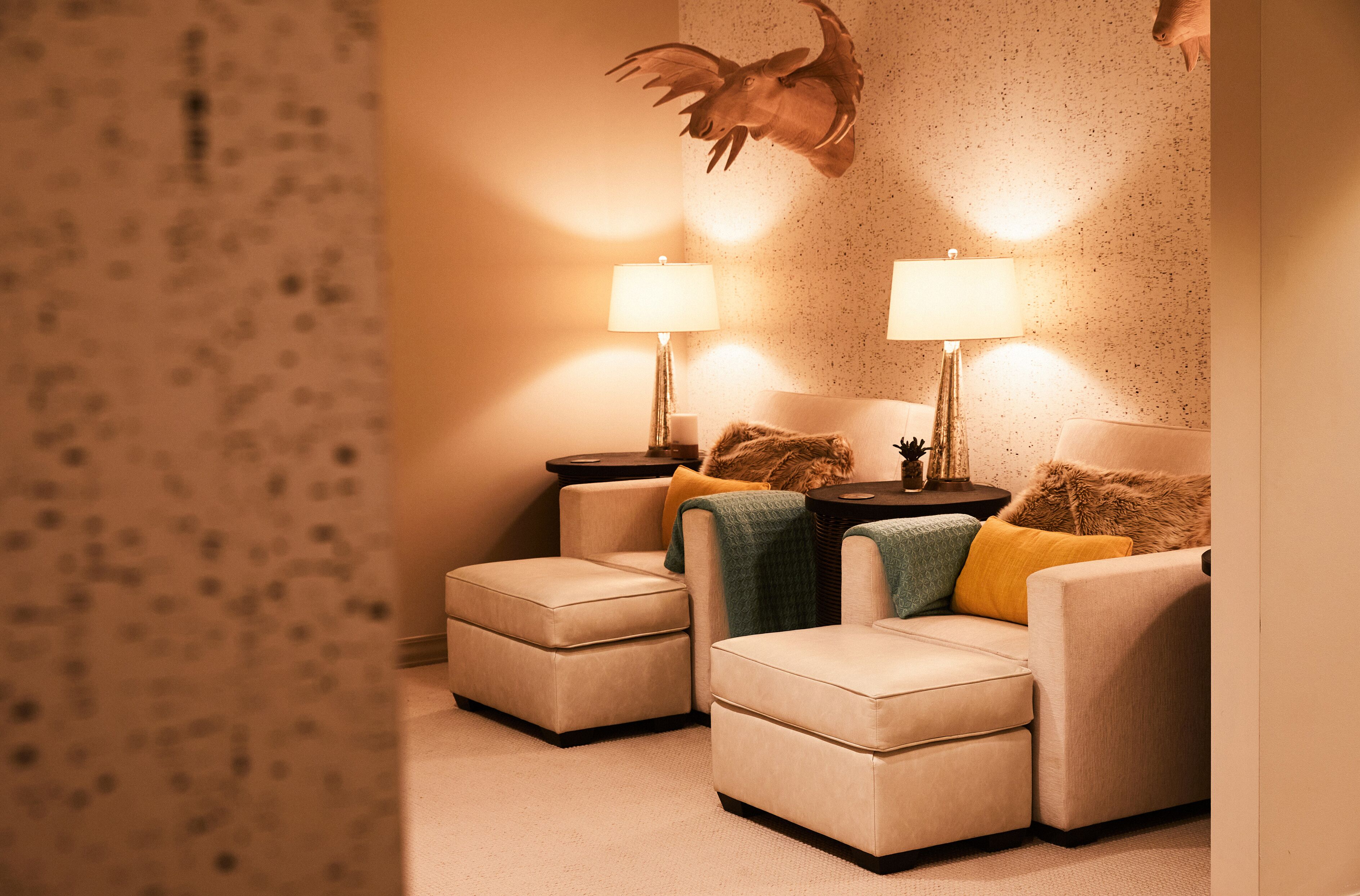 A cozy living room with two sofas, a coffee table, and two lamps.
