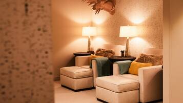 A cozy living room with two sofas, a coffee table, and two lamps.