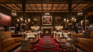 A luxurious hotel lobby with a grand fireplace, elegant furniture, and classic decor.