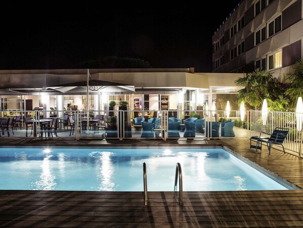 Seasonal outdoor pool, open 9:00 AM to 9:00 PM, pool umbrellas