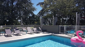 Seasonal outdoor pool, open 9:00 AM to 9:00 PM, pool umbrellas