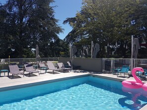 Seasonal outdoor pool, open 9:00 AM to 9:00 PM, pool umbrellas