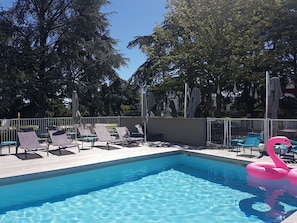 Seasonal outdoor pool, open 9:00 AM to 9:00 PM, pool umbrellas