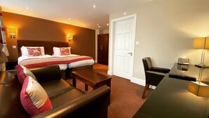 A hotel room with a bed, a sofa, a desk, and a chair. - The Great Barr Hotel (Birmingham)
