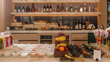 A buffet with various food items and a selection of wine bottles on shelves.