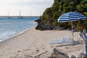 On the beach, white sand, sun loungers, beach umbrellas