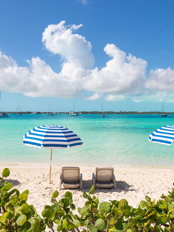 On the beach, white sand, sun loungers, beach umbrellas