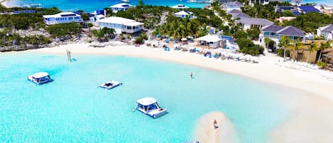 On the beach, white sand, sun-loungers, beach umbrellas