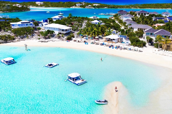 On the beach, white sand, sun loungers, beach umbrellas