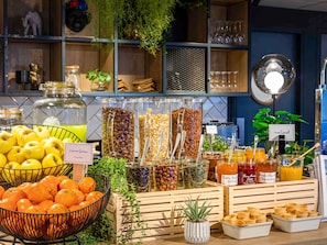 A breakfast buffet with various fruits, cereals, and spreads. - ibis Douai Centre (Douai)