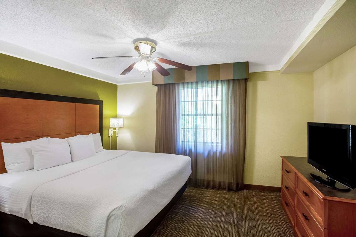 Premium bedding, desk, laptop workspace, iron/ironing board