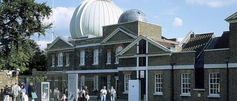 A historic building with a large dome and brick architecture.