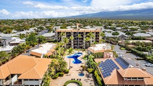 A resort with a central pool, multiple buildings, and a mountainous backdrop. - Maui Beach Vacation Club (Kihei)