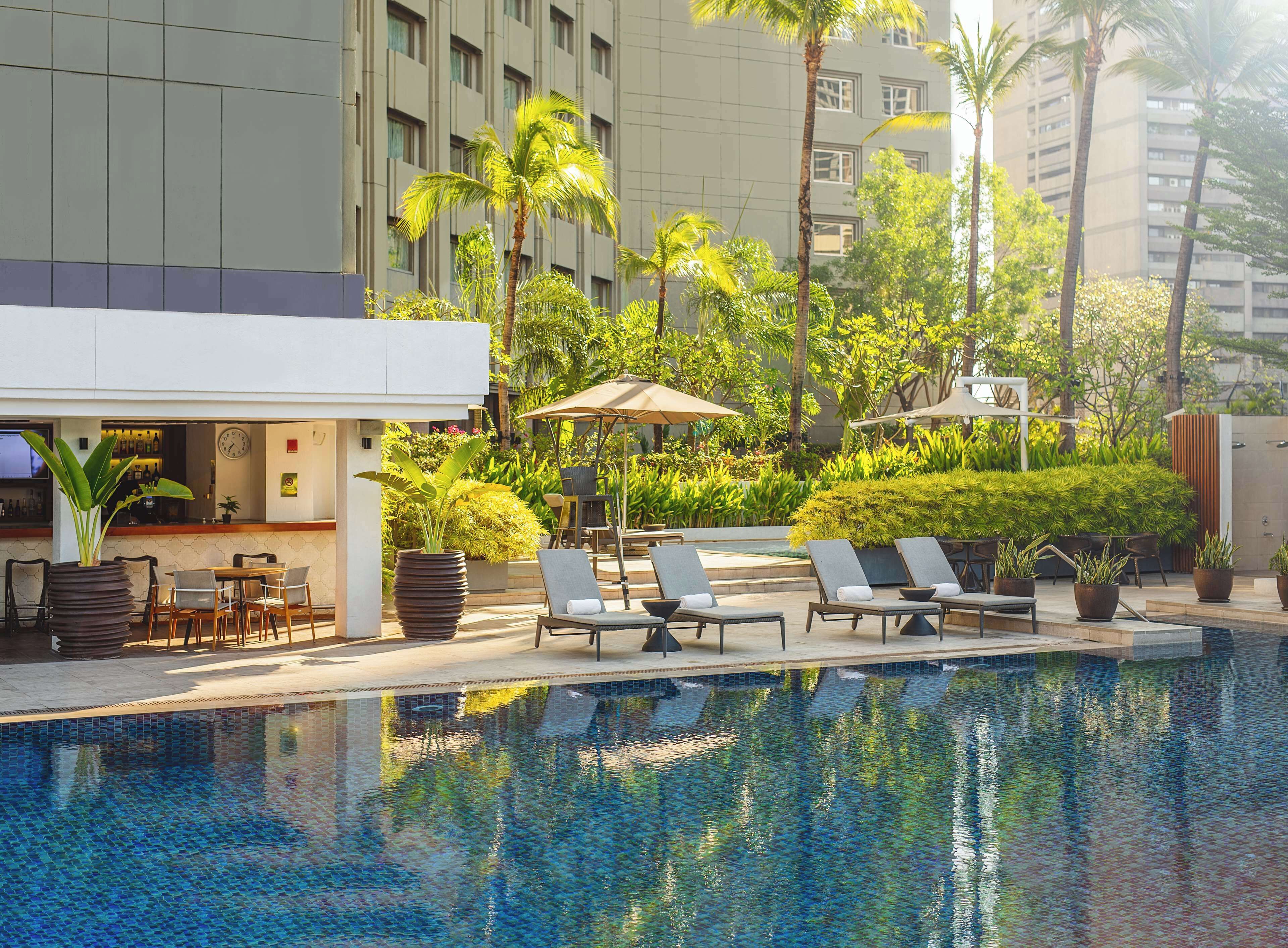 outdoor pool, open 6:00 am to 10:00 pm, pool umbrellas, pool loungers