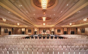 Formal gatherings take place in this elegantly designed conference room, featuring a symmetrical layout and sophisticated ambiance.