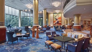A spacious lobby with high ceilings, large windows, and a grand chandelier. - Makati Shangri-La, Manila (Makati)