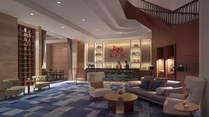 A spacious lobby with a central seating area, a bar, and a staircase. - Makati Shangri-La, Manila (Makati)