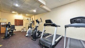 A gym with treadmills, elliptical machines, and weight equipment.