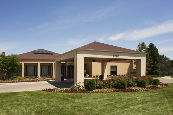 A two-story building with a covered patio area, a brick roof, and a number "7976" on the side. - Courtyard by Marriott Rockford (Rockford)