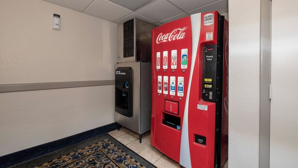 A vending machine with a Coca-Cola logo, a water dispenser, and a 'Thank You!' sign. - Red Roof Inn & Suites Macon (Macon)