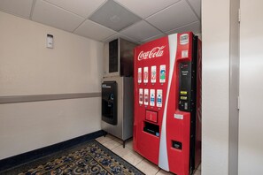 A vending machine with a Coca-Cola logo, a water dispenser, and a 'Thank You!' sign. - Red Roof Inn & Suites Macon (Macon)