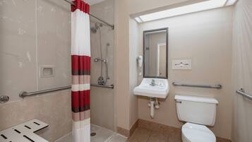 A bathroom with a shower, a sink, and a toilet.