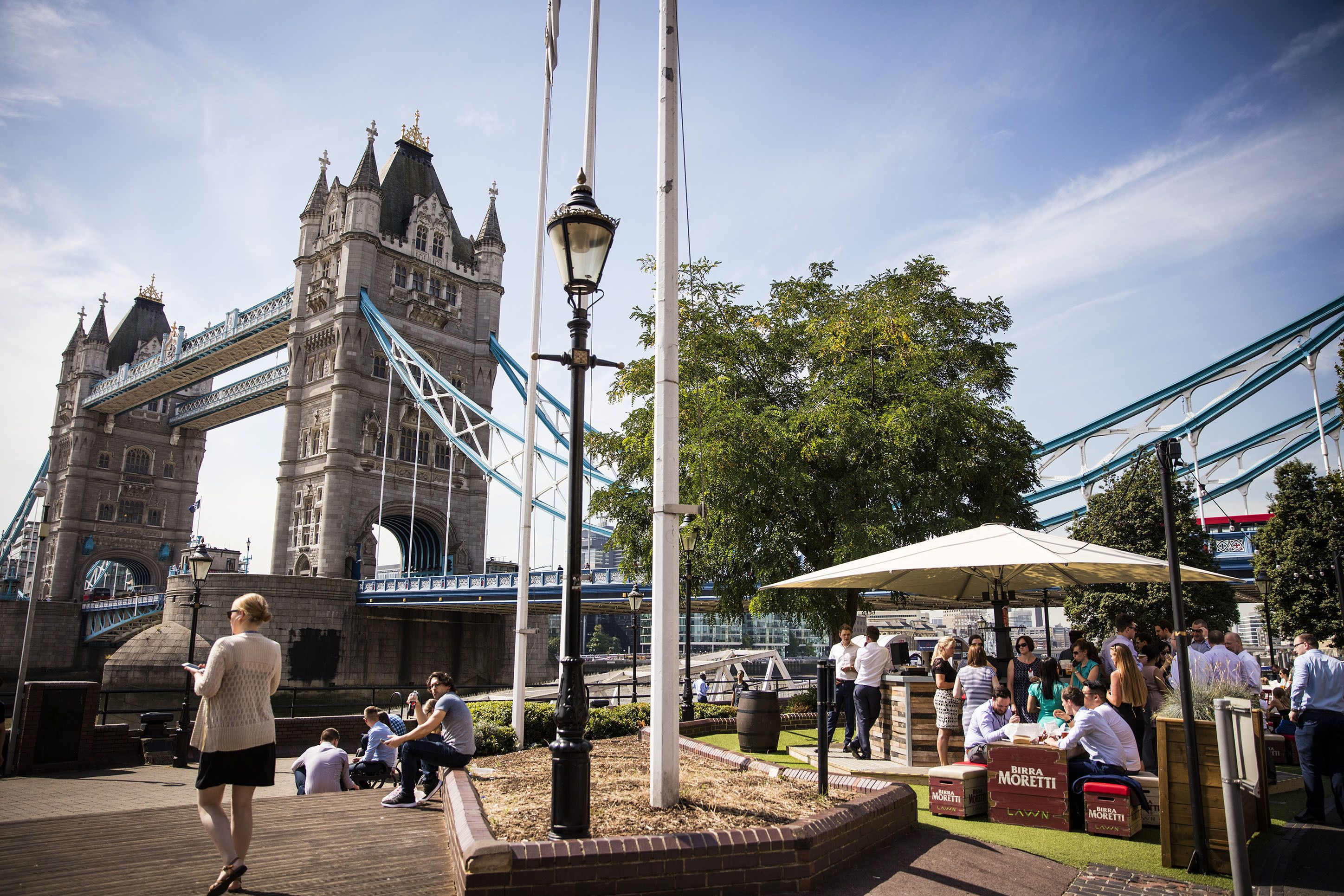 A historic bridge with a pedestrian walkway and a seating area with a canopy.