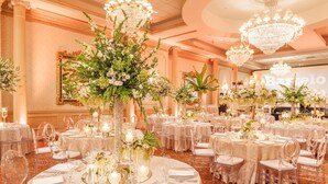 A banquet hall with round tables, clear chairs, and floral centerpieces. - Barceló Guatemala City (Guatemala City)