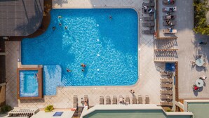 A rooftop swimming pool with multiple sections, sun loungers, and a small adjacent pool. - Barceló Guatemala City (Guatemala City)