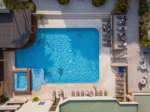 A rooftop swimming pool with multiple sections, sun loungers, and a small adjacent pool. - Barceló Guatemala City (Guatemala City)