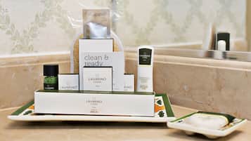 A bathroom counter with a LAVARINO COSSO dental kit, a bottle of RINO so, and a clear plastic bag containing a product.