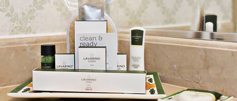 A bathroom counter with a LAVARINO COSSO dental kit, a bottle of RINO so, and a clear plastic bag containing a product.