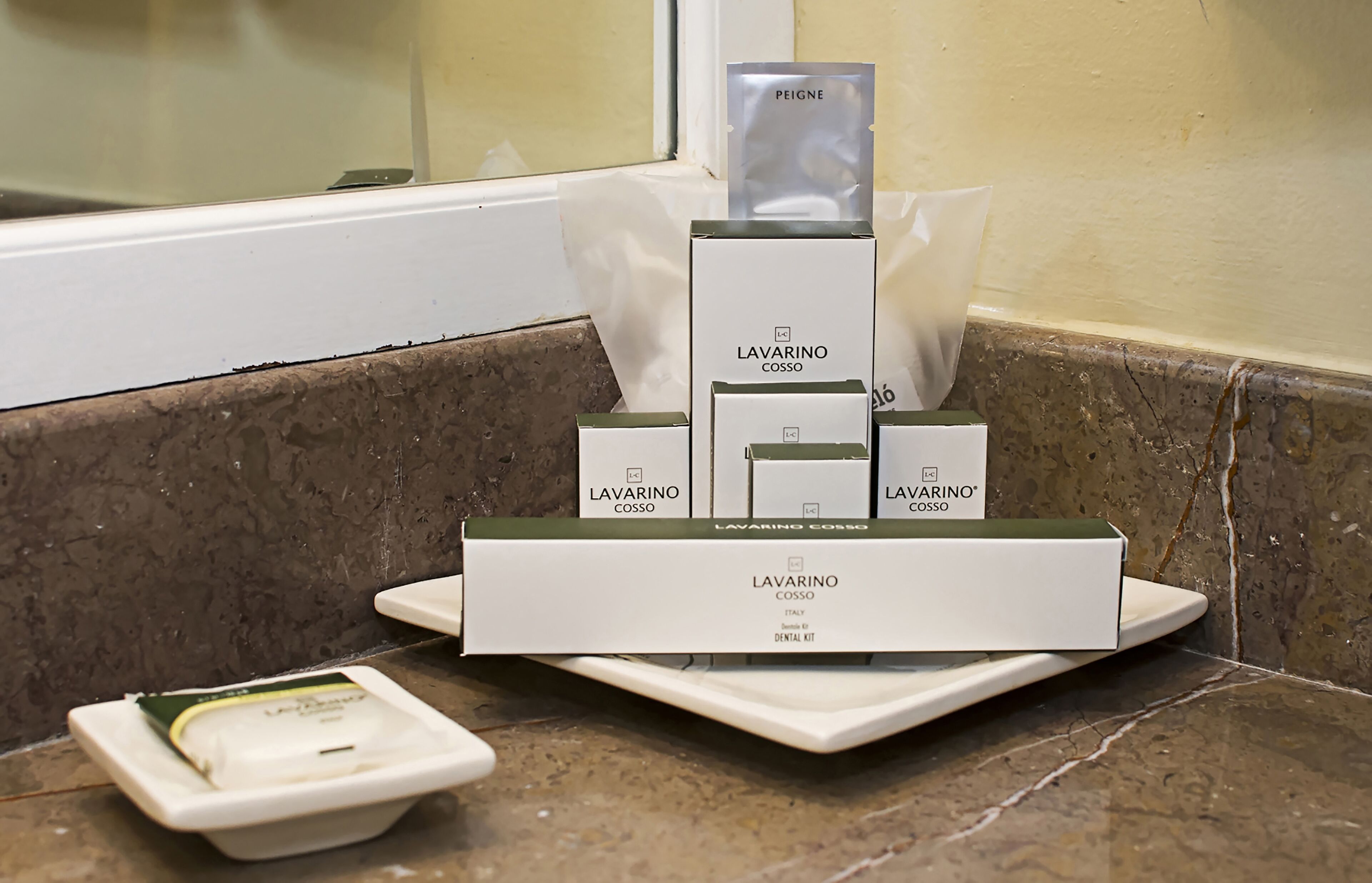 A dental care kit with LAVARINO COSSO products on a bathroom counter.