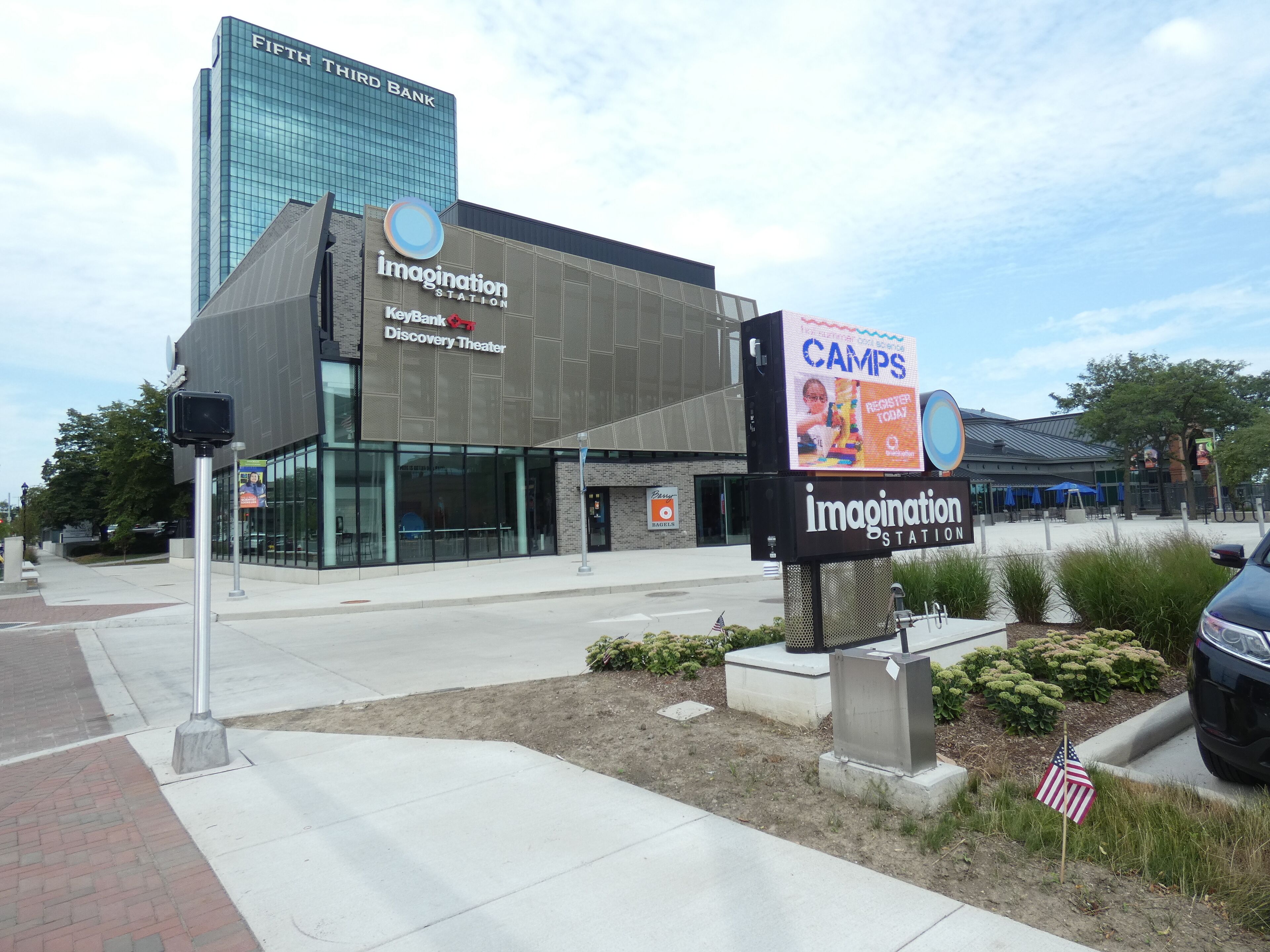 A modern building with a large sign for 'imagination station' and a smaller sign for 'KeyBank Discovery Theater'.