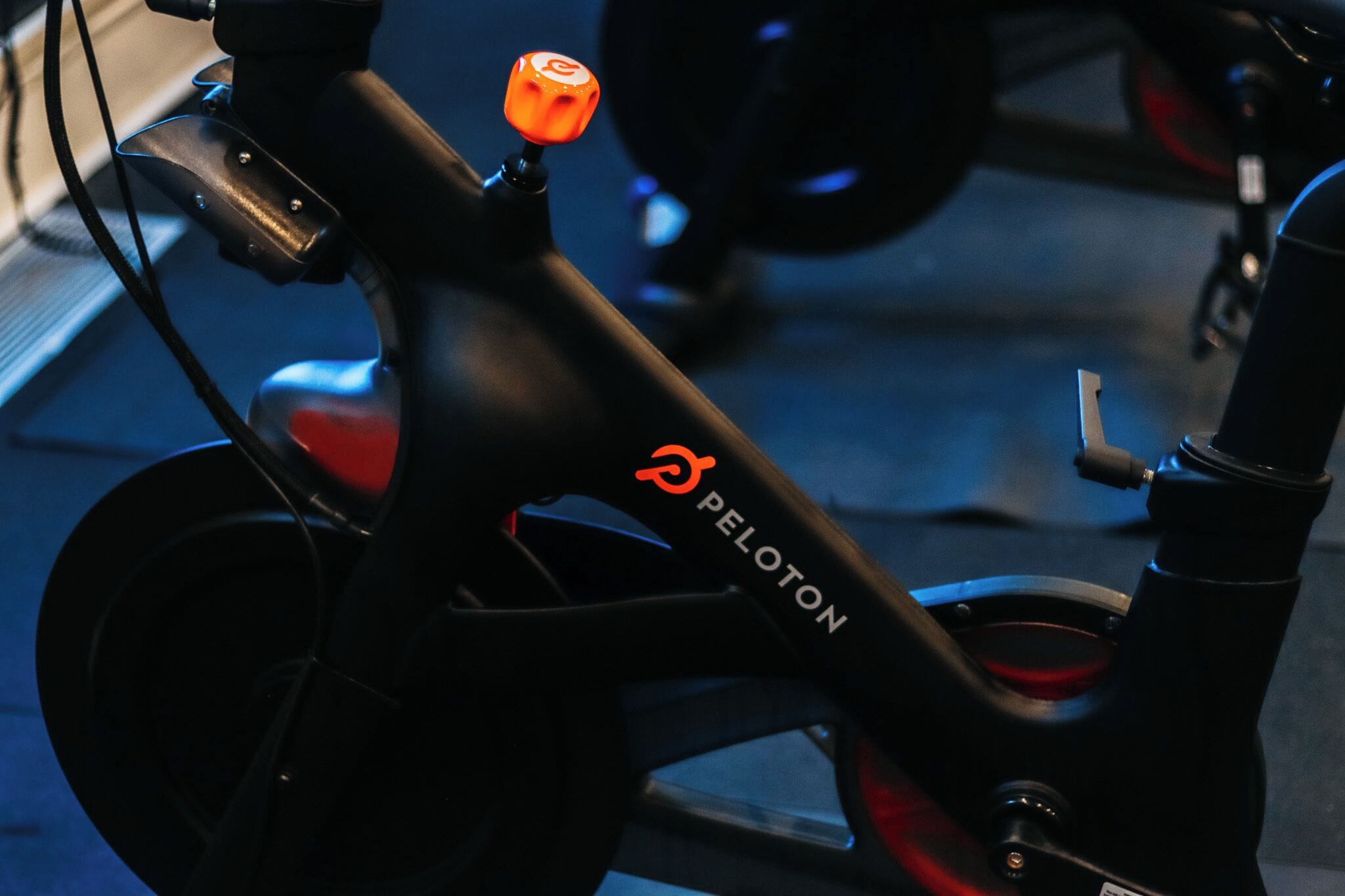 A close-up of a bicycle with the brand name 'PELOTON' on the frame.