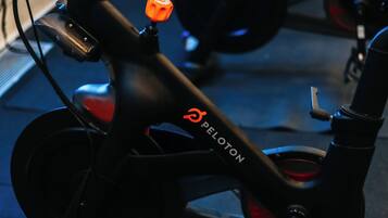 A close-up of a bicycle with the brand name 'PELOTON' on the frame.
