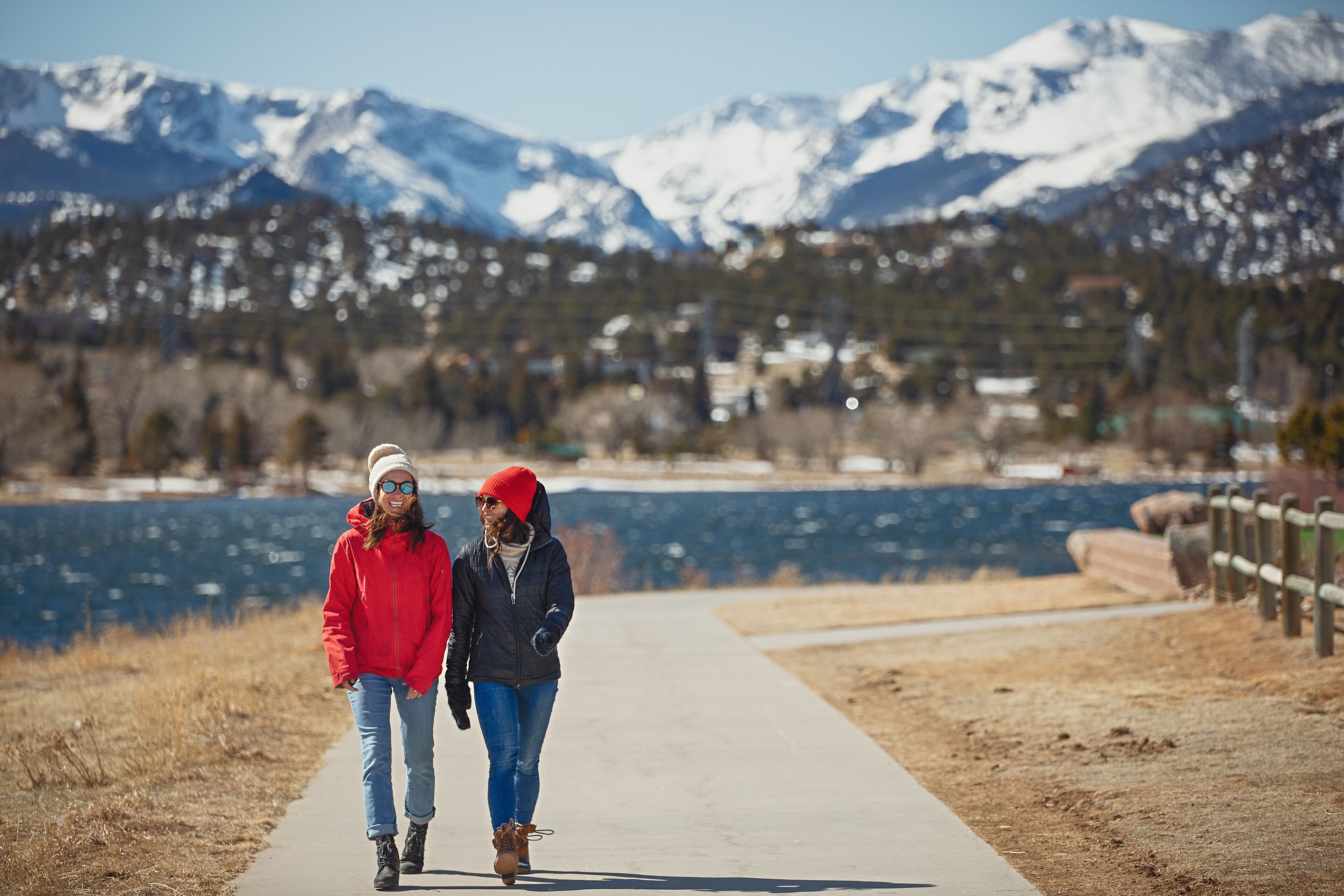 A pathway with a view of mountains and a lake.