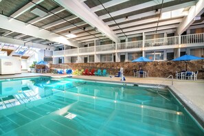 Relax by the pool surrounded by lounge chairs and take in the views from the upper balconies.
