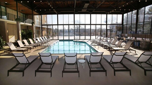 A poolside area with sun loungers and a clear view of the outdoors.