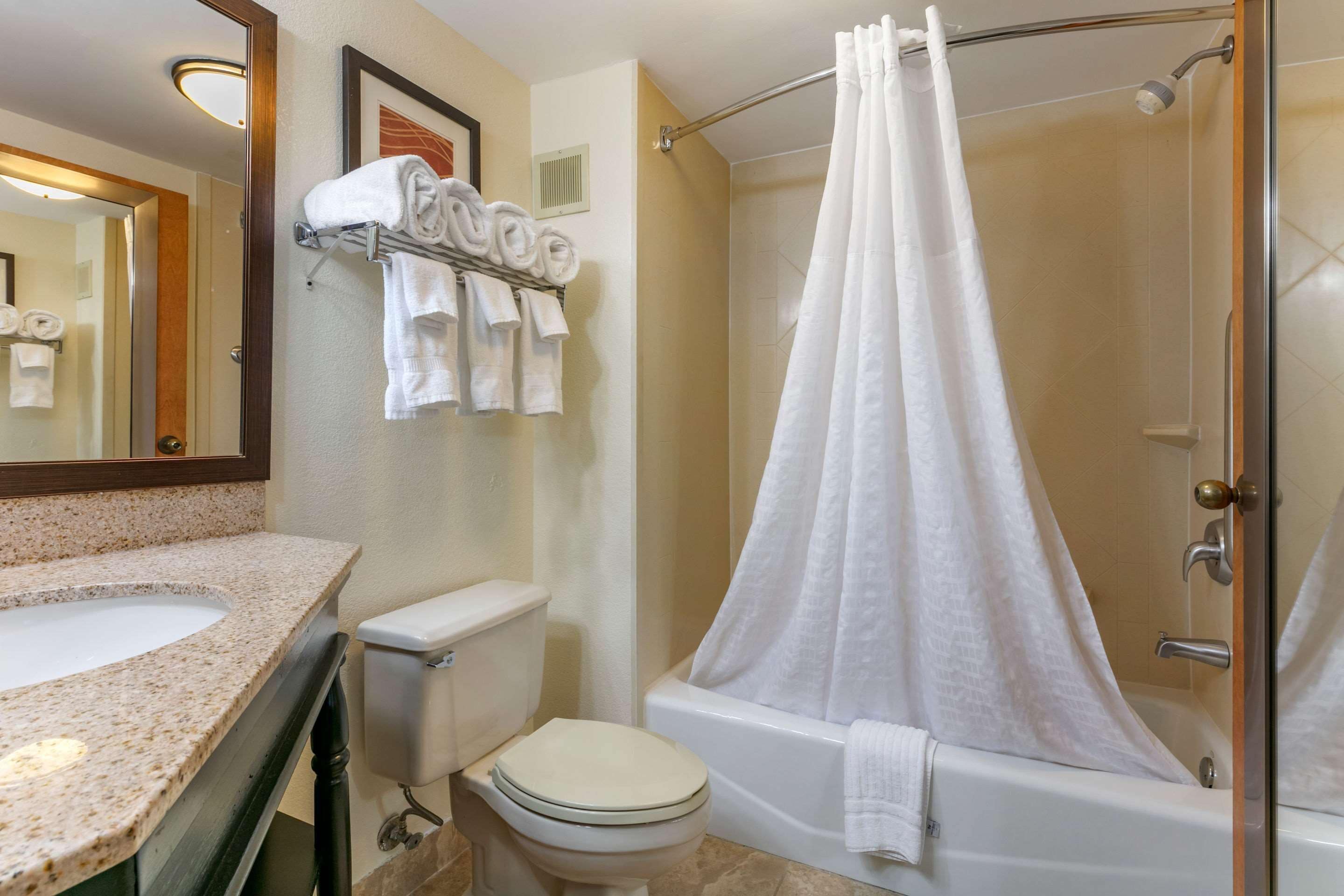 A bathroom with a sink, toilet, and bathtub.