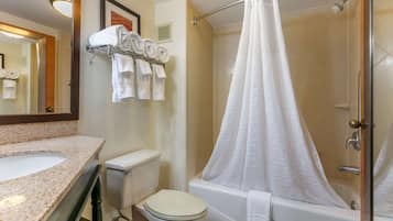 A bathroom with a sink, toilet, and bathtub.