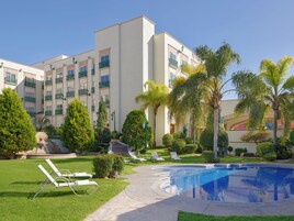 Una piscina al aire libre, camas de piscina gratis, sombrillas