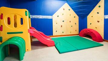 Kids can climb, slide, and play on the colorful play structure with a padded mat for safety.
